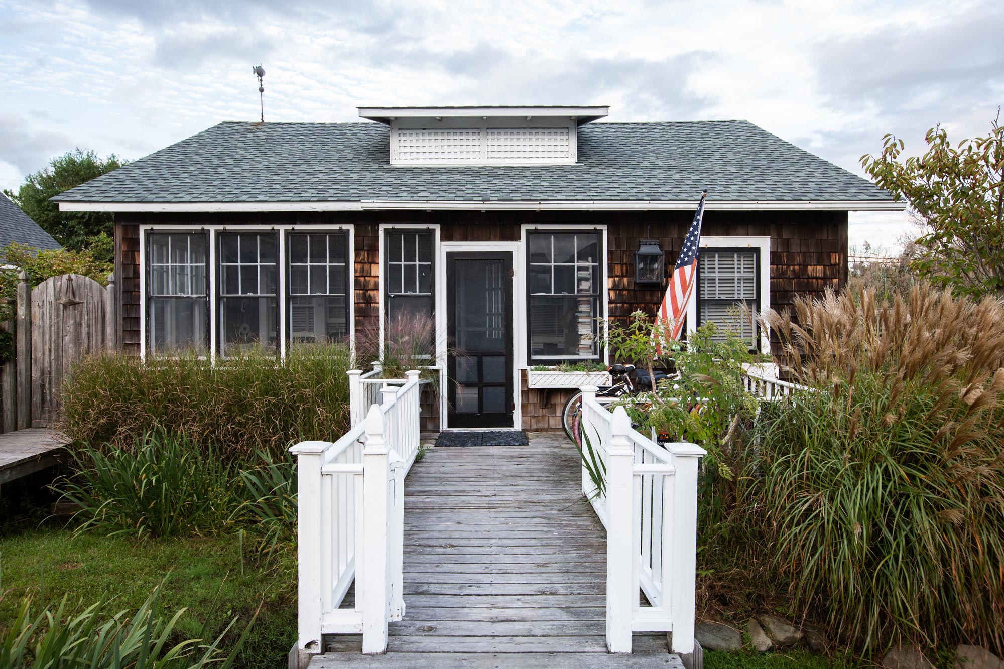 “Everything’s on stilts,” Bates says of Fire Island’s flood-resistant houses and other structures. “Our place is a lower one. We’re about four feet off the ground. Since Hurricane Sandy, a lot of people have had to raise their houses; we haven’t got…