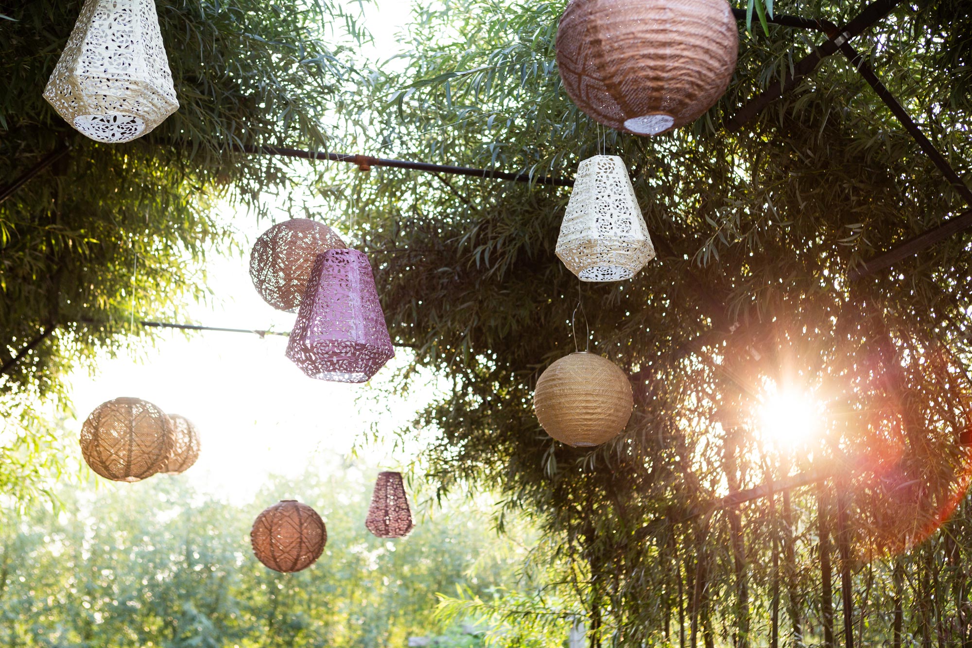 Overhead, lacy, solar-powered Terrain lanterns hang, purposely pell-mell, swaying in the breeze from the trellised archway in the chef’s garden.