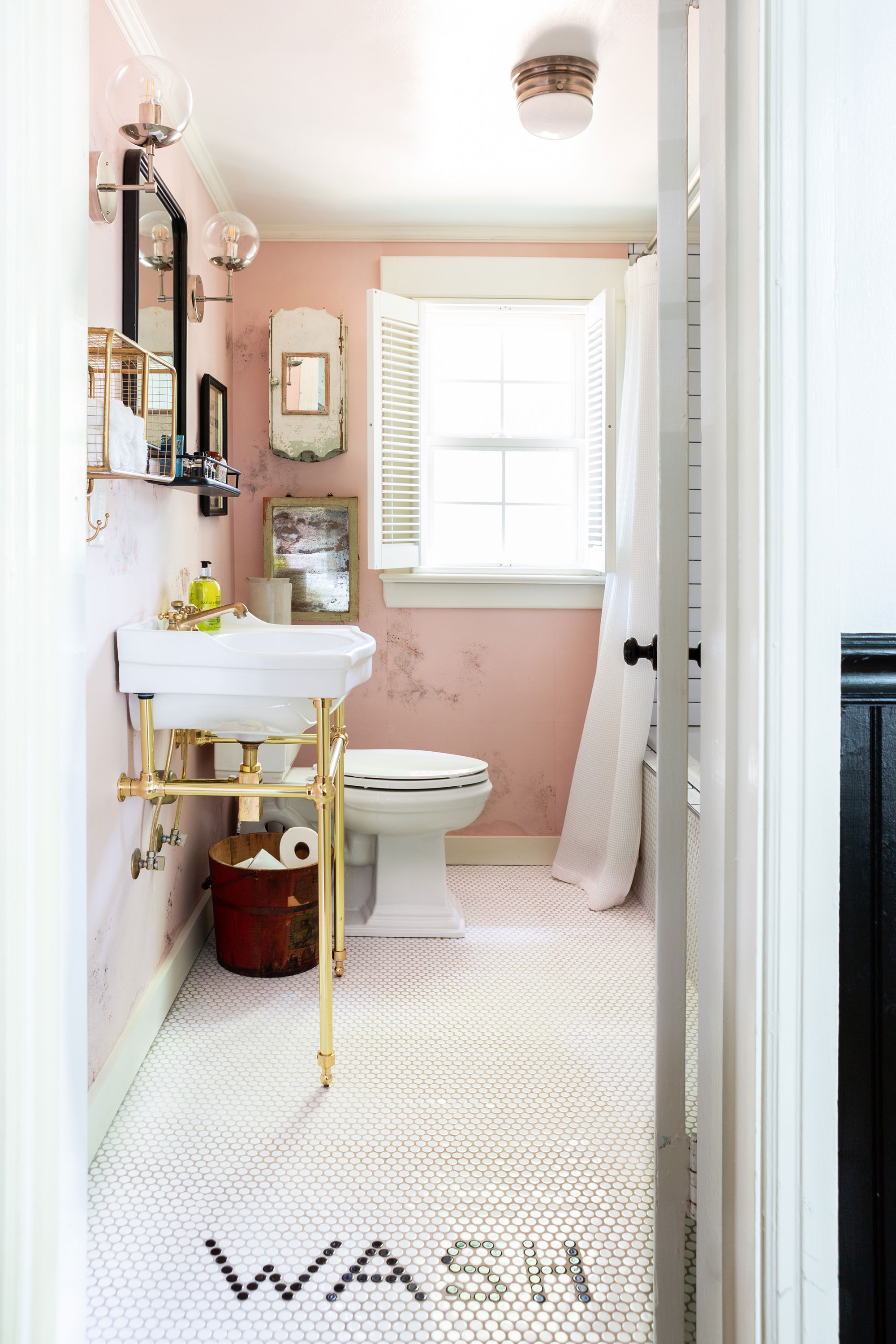 “No Southern home is complete without a stylish bathroom,” Holly says of her brassy, gold-on-pink design for the cottage’s renovated water closet. “There’s absolutely got to be a soaking tub, too.”